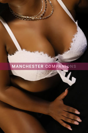 Close up of Crystal's pert cleavage weraing a white lacey 2 piece lingerie set